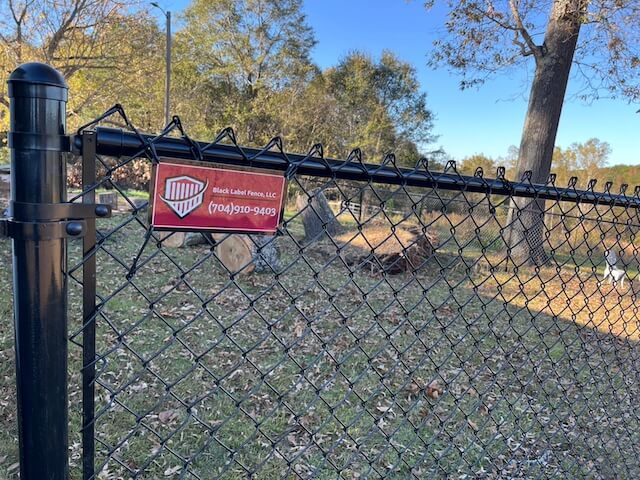 black chain link fence with a fence tag | Black Label fence, LLC
