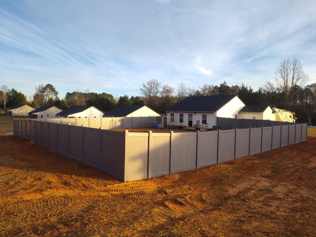 Gray vinyl privacy fence Installed by Black Label Fence, LLC.
