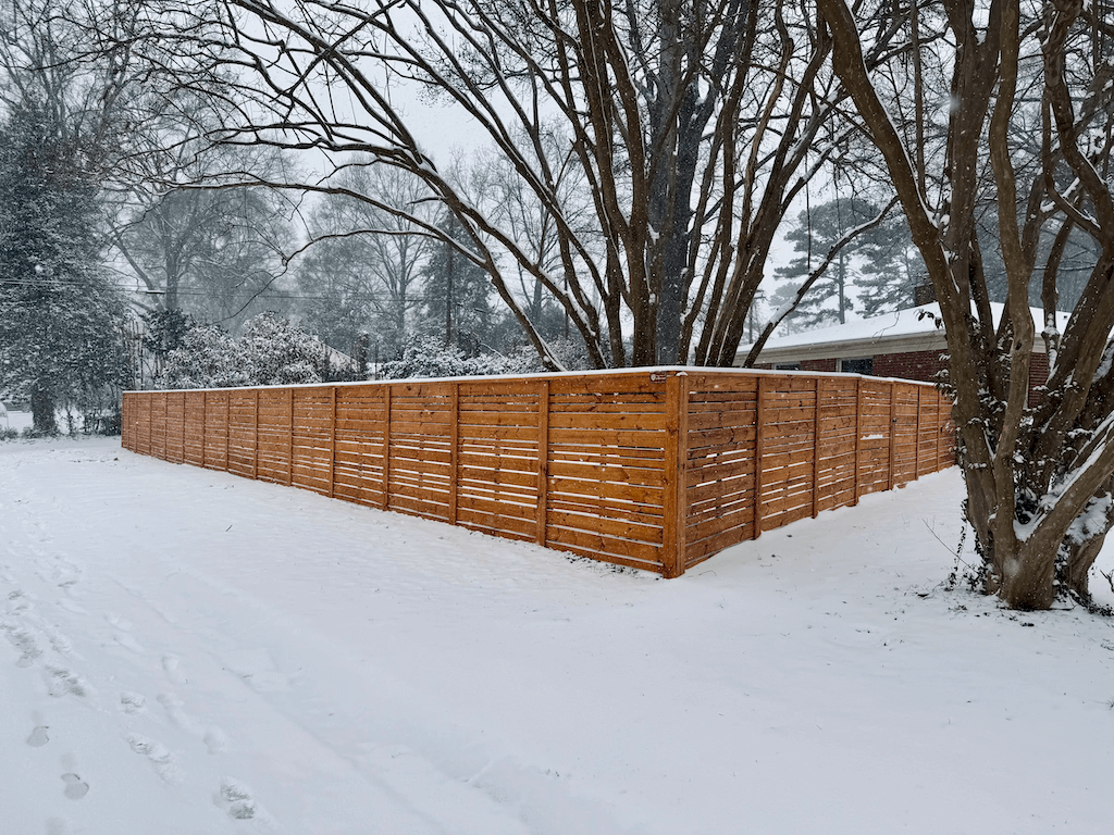 Horizontal wood fence on snow day | installation by black label fence