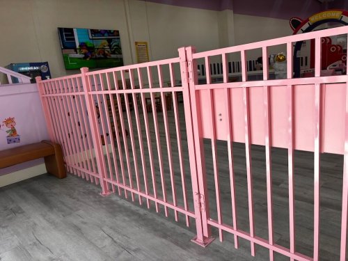 Pink aluminum fence with panic bars