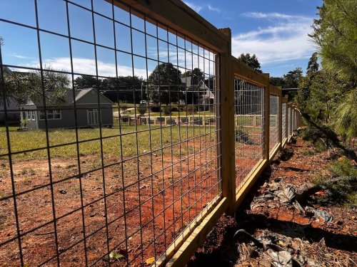 Hog wire panel fence