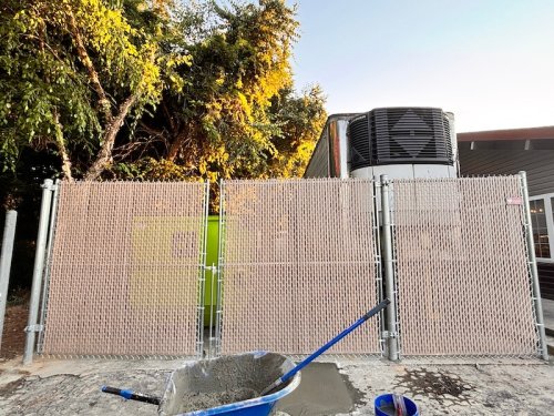 8' high chain link tan privacy slats on gates- Golden corral Asheboro, NC.
