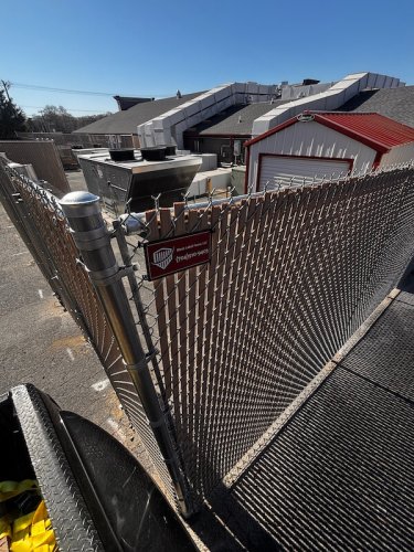 8' high chain link tan privacy slats on Fence- Golden corral Concord, NC.