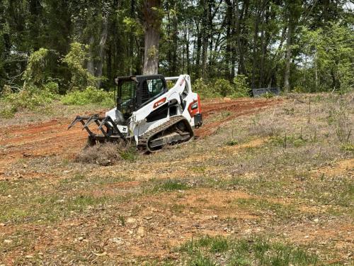 Grading a Backyard with a Bobcat loader in Shelby NC.